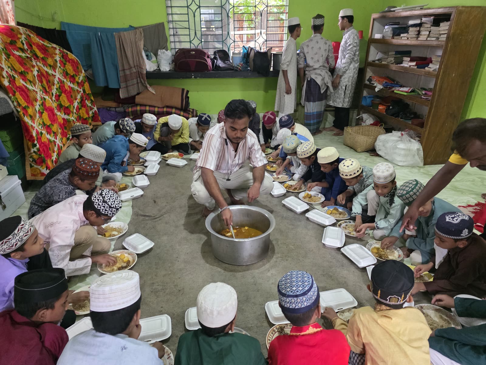 Meal service documented for orphan children at a madrasa in Bangladesh